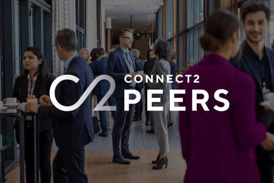 Group of conference attendees mingling with Connect2Peers logo
