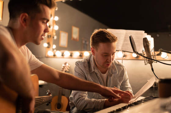Two teenage boys recording music in a studio